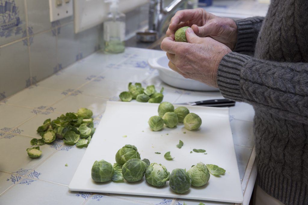 Dr. Guy Crosby holding a Brussels sprout