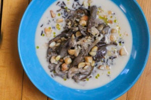 Braised Oyster Mushrooms, Coconut, and Macadamia nuts in a blue bowl