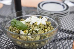 Pasta salad with basil pesto, corn, zucchini,