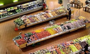 supermarket aisles full of produce and people shopping